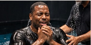 A man rejoicing during baptism