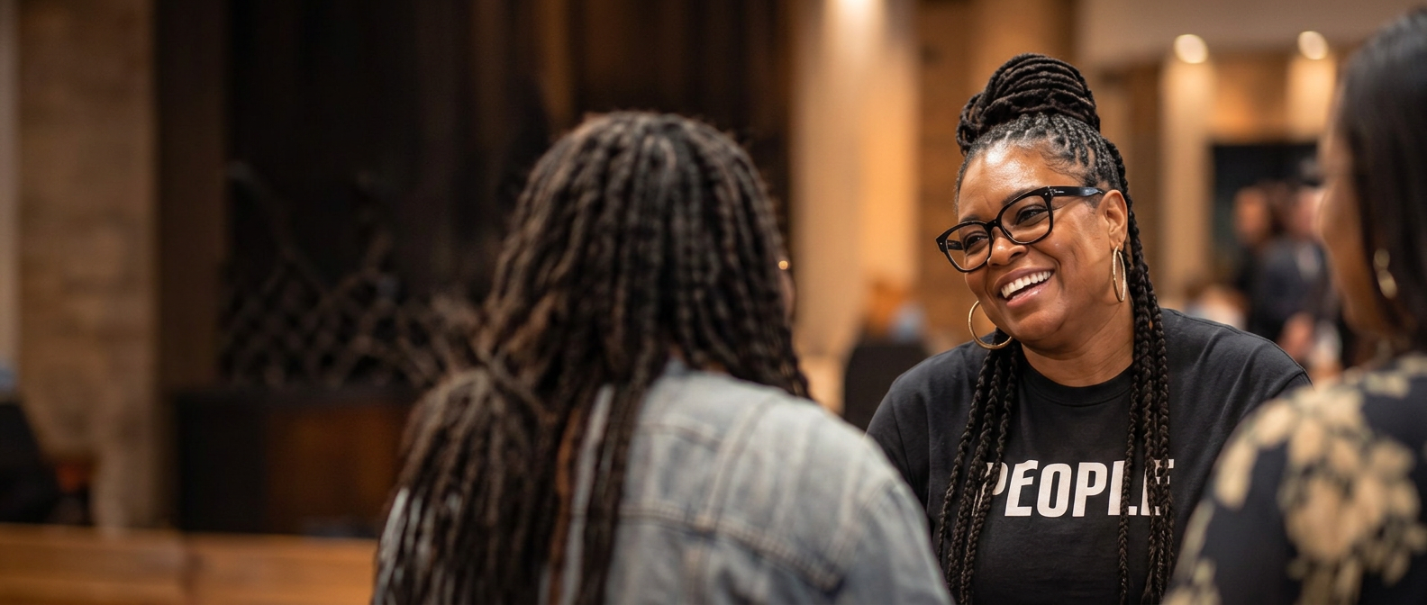 A smiling Faith Fellowship member in conversation during a ministry gathering