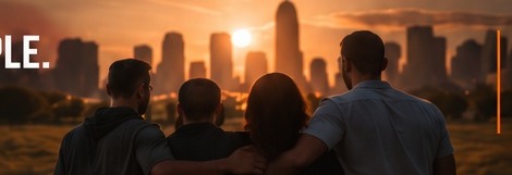 A family looking out over a city skyline at sunset