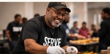 Volunteer serving a meal
